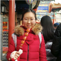 Jing stands in a food market.