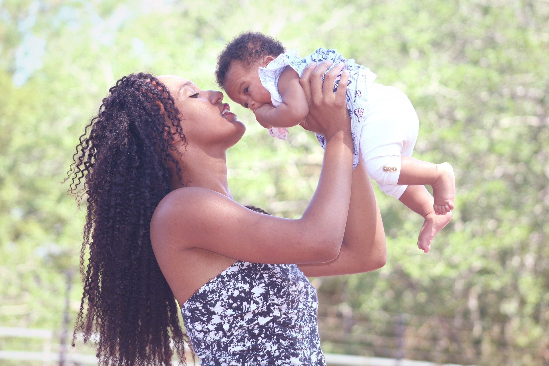 A mother holds her child up.